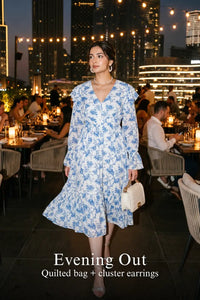 Woman in Pretty Pixie light blue toile floral ruffle v-neck midi dress styled for an evening out