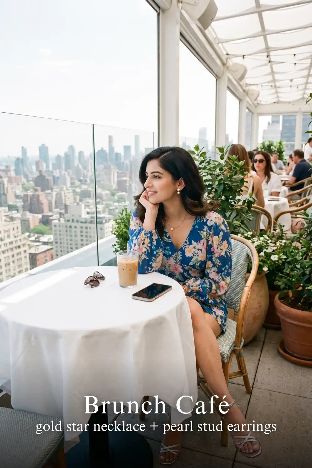 Woman in Pretty Pixie blue floral v-neck belted long-sleeve mini dress styled for a luxe brunch cafe