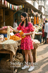 Woman in Pretty Pixie olivia pleated floral puff-sleeve mini dress styled for a sunday market