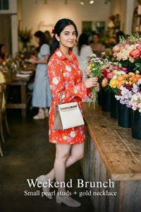 Woman in Pretty Pixie crimson floral belted mini dress styled for a weekend brunch