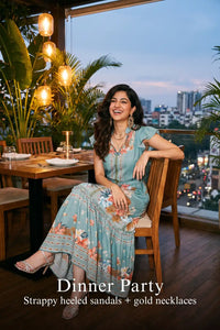 Woman in Pretty Pixie dusty teal flutter-sleeve belted midi dress styled for a dinner party 4