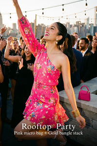 Woman in Pretty Pixie fuchsia floral one-shoulder ruffle mini dress styled for a rooftop party