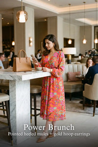 Woman in Pretty Pixie fuchsia paisley v-neck smocked midi dress styled for a power brunch