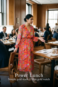 Woman in Pretty Pixie fuchsia paisley v-neck smocked midi dress styled for a power lunch