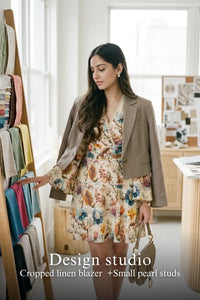 Woman in Pretty Pixie ivory floral wrap long-sleeve mini dress styled for a design studio