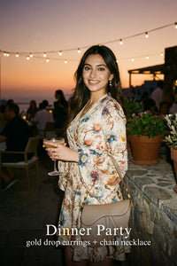 Woman in Pretty Pixie ivory floral wrap long-sleeve mini dress styled for a dinner party