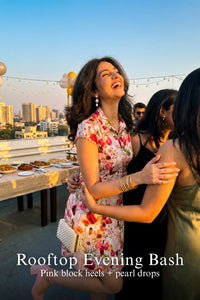 Woman in Pretty Pixie ivory rose print collared sleeveless mini dress styled for a rooftop evening bash