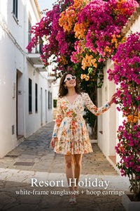 Woman in Pretty Pixie ivory floral v-neck tiered mini dress styled for a resort holiday