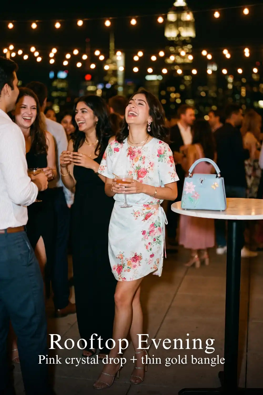 Woman in Pretty Pixie powder blue floral tie-waist mini dress styled for a rooftop evening
