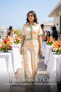 Woman in Pretty Pixie ivory & green floral co-ord set styled for a hotel brunch cafe
