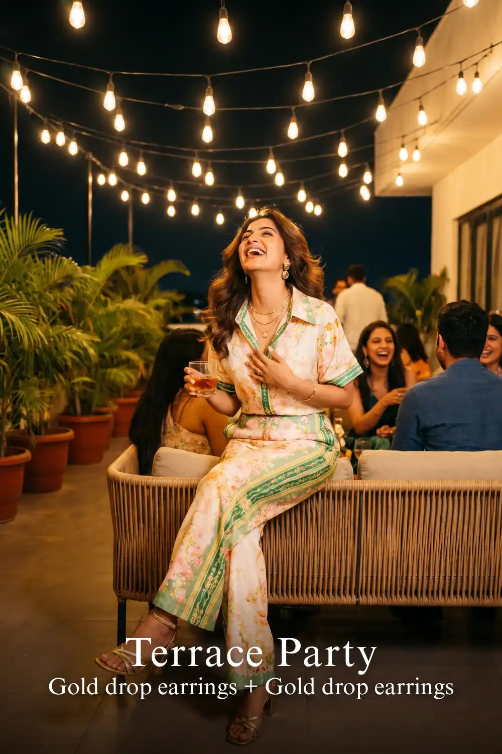 Woman in Pretty Pixie ivory & green floral co-ord set styled for a terrace party