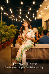 Woman in Pretty Pixie ivory & green floral co-ord set styled for a terrace party