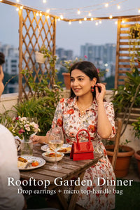 Woman in Pretty Pixie ivory floral cotton button-down belted mini dress styled for a rooftop garden dinner