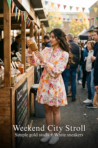 Woman in Pretty Pixie ivory floral long-sleeve button mini dress styled for a weekend city stroll