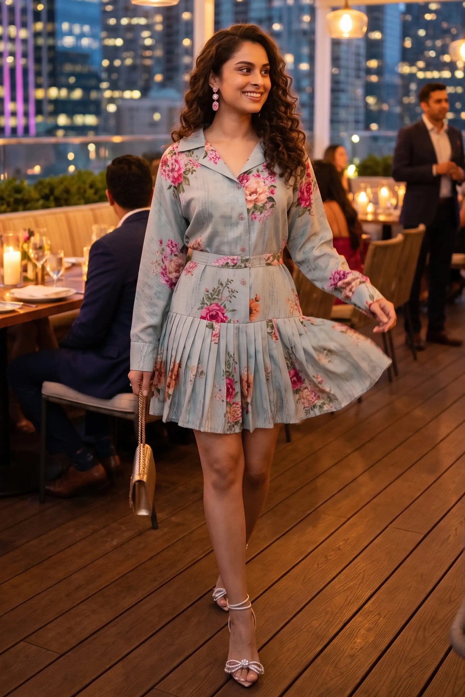 Woman walking at a rooftop dinner wearing Pretty Pixie's mint floral belted pleated shirt mini dress