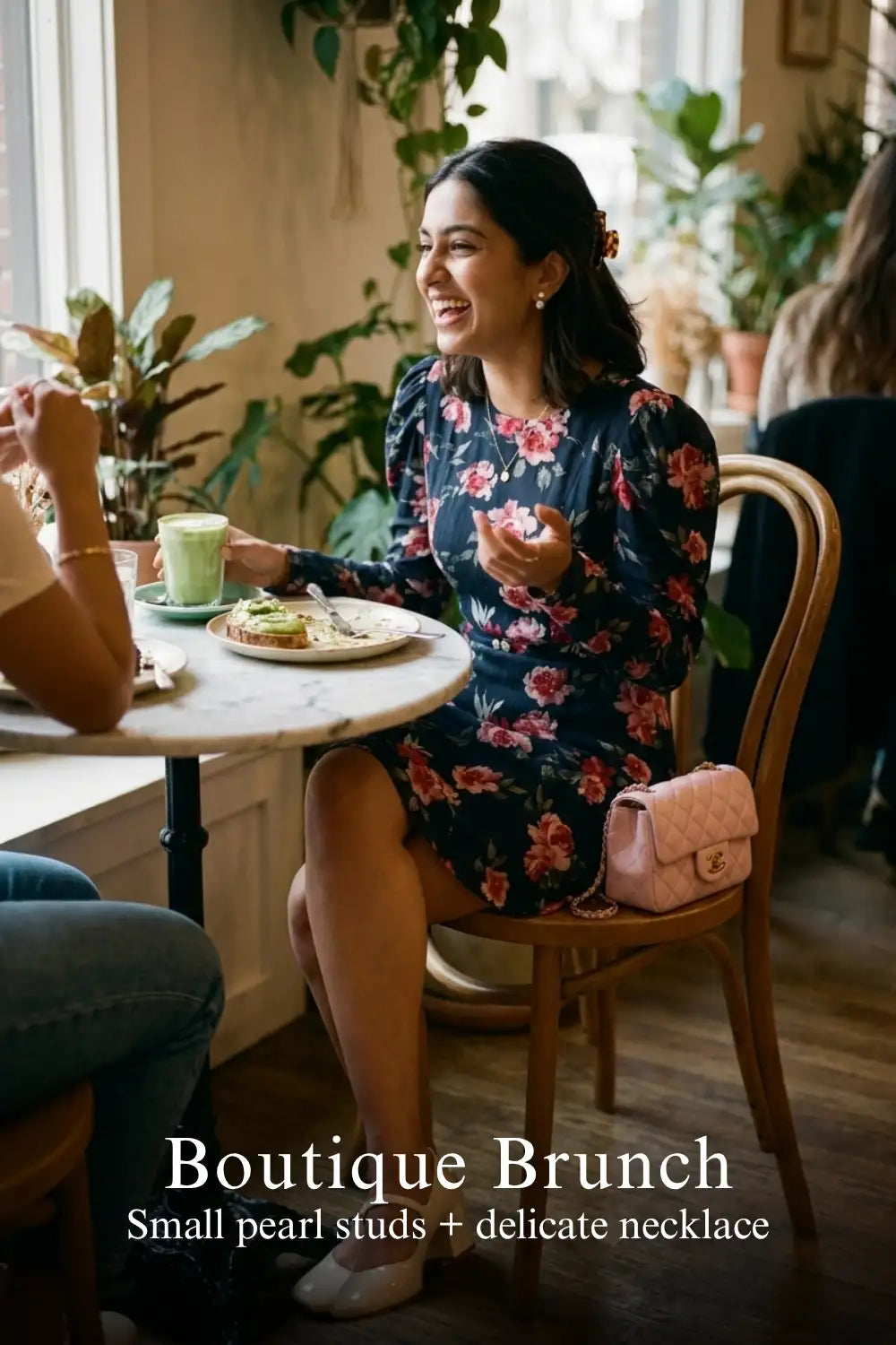 Woman in Pretty Pixie navy floral puff-sleeve belted mini dress styled for a boutique brunch