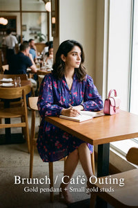 Woman in Pretty Pixie royal indigo floral v-neck puff-sleeve belted mini dress styled for a brunch cafe outing