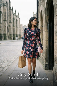 Woman in Pretty Pixie navy floral puff-sleeve belted mini dress styled for a city stroll
