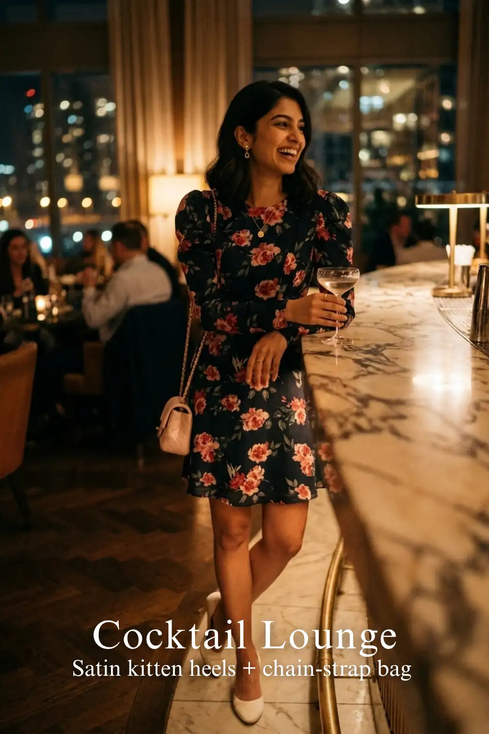 Woman in Pretty Pixie navy floral puff-sleeve belted mini dress styled for a cocktail lounge