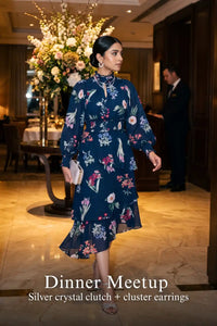 Woman in Pretty Pixie twilight rose navy floral ruffle hi-low midi dress styled for a dinner meetup