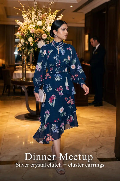 Woman in Pretty Pixie twilight rose navy floral ruffle hi-low midi dress styled for a dinner meetup