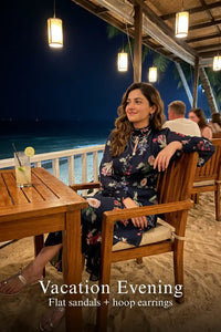 Woman in Pretty Pixie twilight rose navy floral ruffle hi-low midi dress styled for a vacation evening