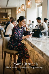 Woman in Pretty Pixie navy floral belted shirt & wide-leg co-ord set styled for a power brunch