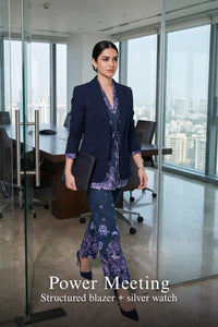 Woman in Pretty Pixie navy paisley belted blazer & flared pants co-ord set styled for a power meeting