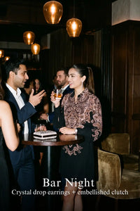 Woman in Pretty Pixie navy paisley belted long-sleeve shirt dress styled for a bar night