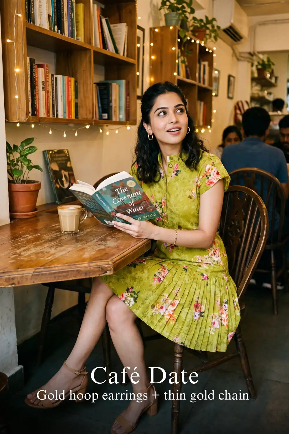 Woman in Pretty Pixie olive floral belted pleated shirt mini dress styled for a cafe date