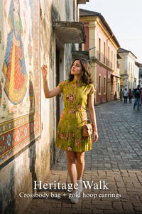 Woman in Pretty Pixie olive floral belted pleated shirt mini dress styled for a heritage walk
