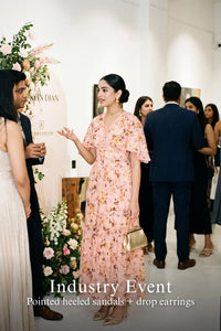 Woman in Pretty Pixie peach floral ruffle maxi dress styled for an industry event