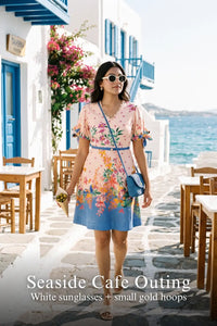 Woman in Pretty Pixie pastel pink riviera floral v-neck mini dress styled for a seaside cafe outing