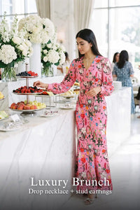 Woman in Pretty Pixie pink floral v-neck long-sleeve maxi dress styled for a luxury brunch