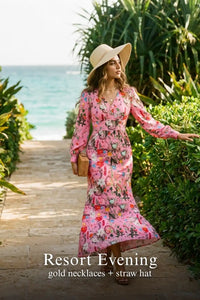 Woman in Pretty Pixie pink floral v-neck long-sleeve maxi dress styled for a resort evening