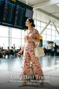 Woman in Pretty Pixie pink floral collared half-sleeve belted wide-leg jumpsuit styled for a travel outfit