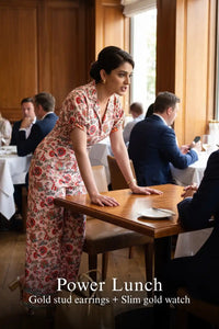 Woman in Pretty Pixie pink floral collared half-sleeve belted wide-leg jumpsuit styled for a power lunch