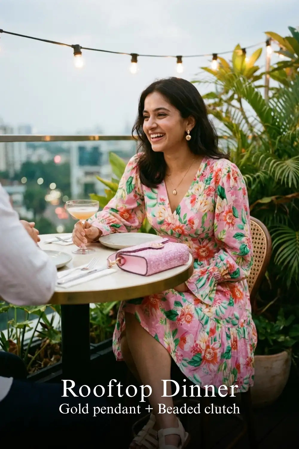Woman in Pretty Pixie orchid pink floral tiered ruffle long-sleeve mini dress styled for a rooftop dinner