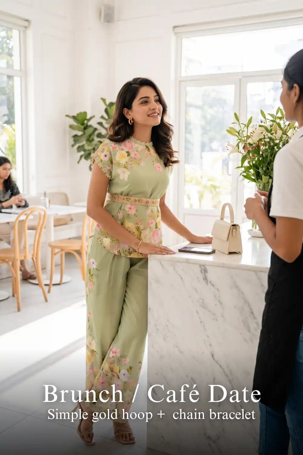 Woman in Pretty Pixie sage green floral co-ord top & wide pants styled for a brunch cafe date