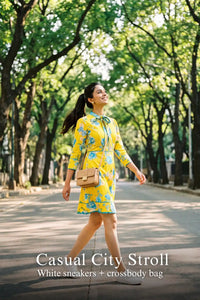 Woman in Pretty Pixie sunshine yellow floral bow-tie mini dress styled for a casual city stroll