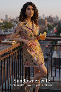 Woman in Pretty Pixie tan floral button-front mini dress styled for a sundowner cafe