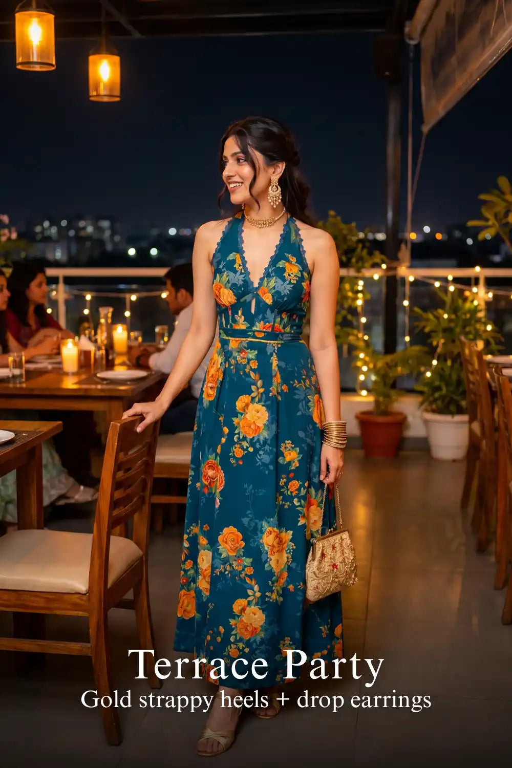 Woman in Pretty Pixie sunset crush royal indigo floral halter maxi dress styled for a terrace party