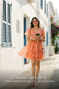 Woman in Pretty Pixie peach blossom floral v-neck flutter sleeve mini dress styled for a casual getaway