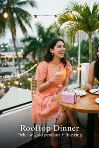 Woman in Pretty Pixie peach blossom floral v-neck flutter sleeve mini dress styled for a rooftop dinner