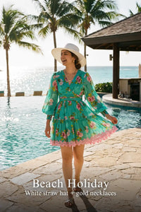 Woman in Pretty Pixie turquoise floral v-neck puff-sleeve lace-hem mini dress styled for a beach holiday