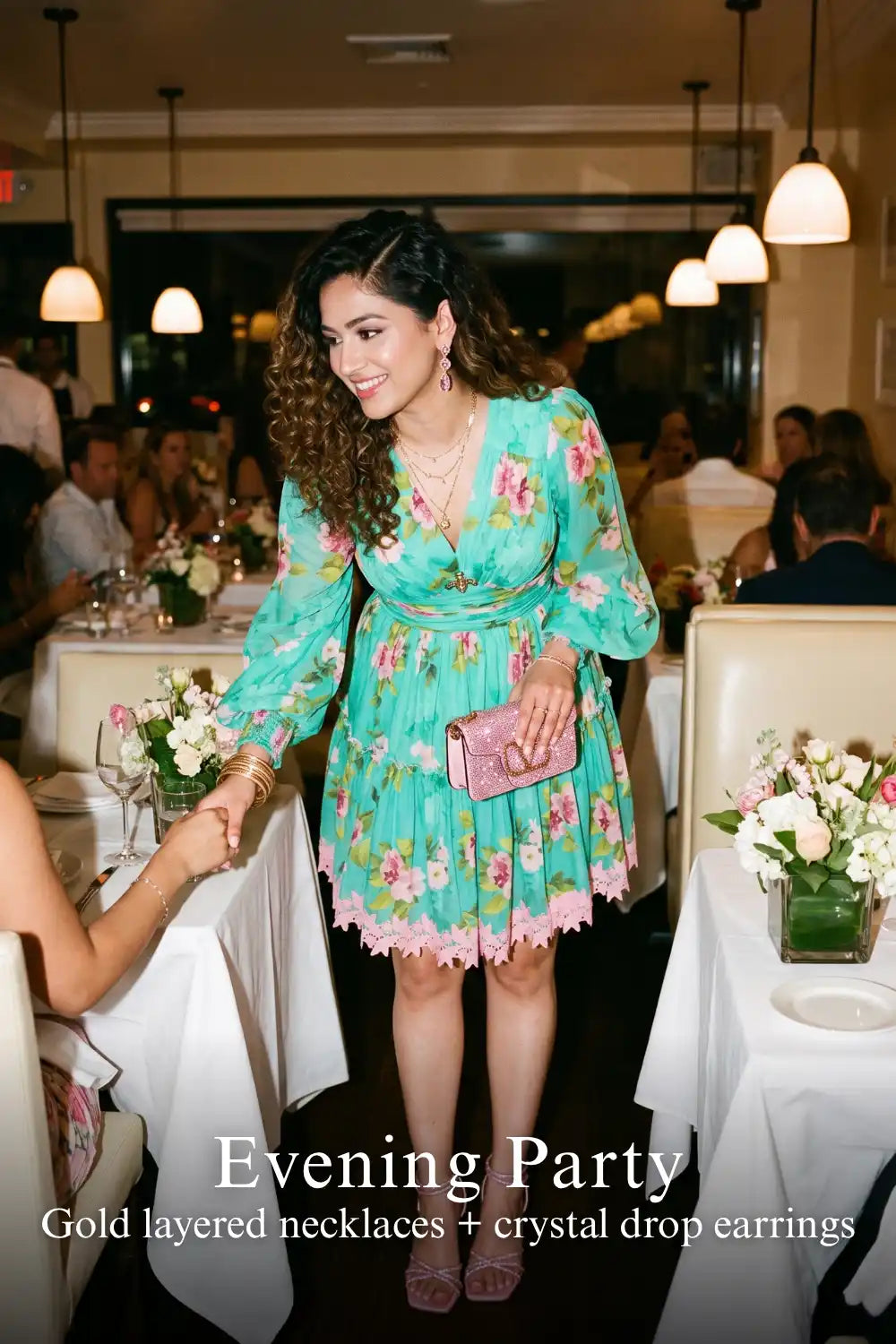 Woman in Pretty Pixie turquoise floral v-neck puff-sleeve lace-hem mini dress styled for an evening party