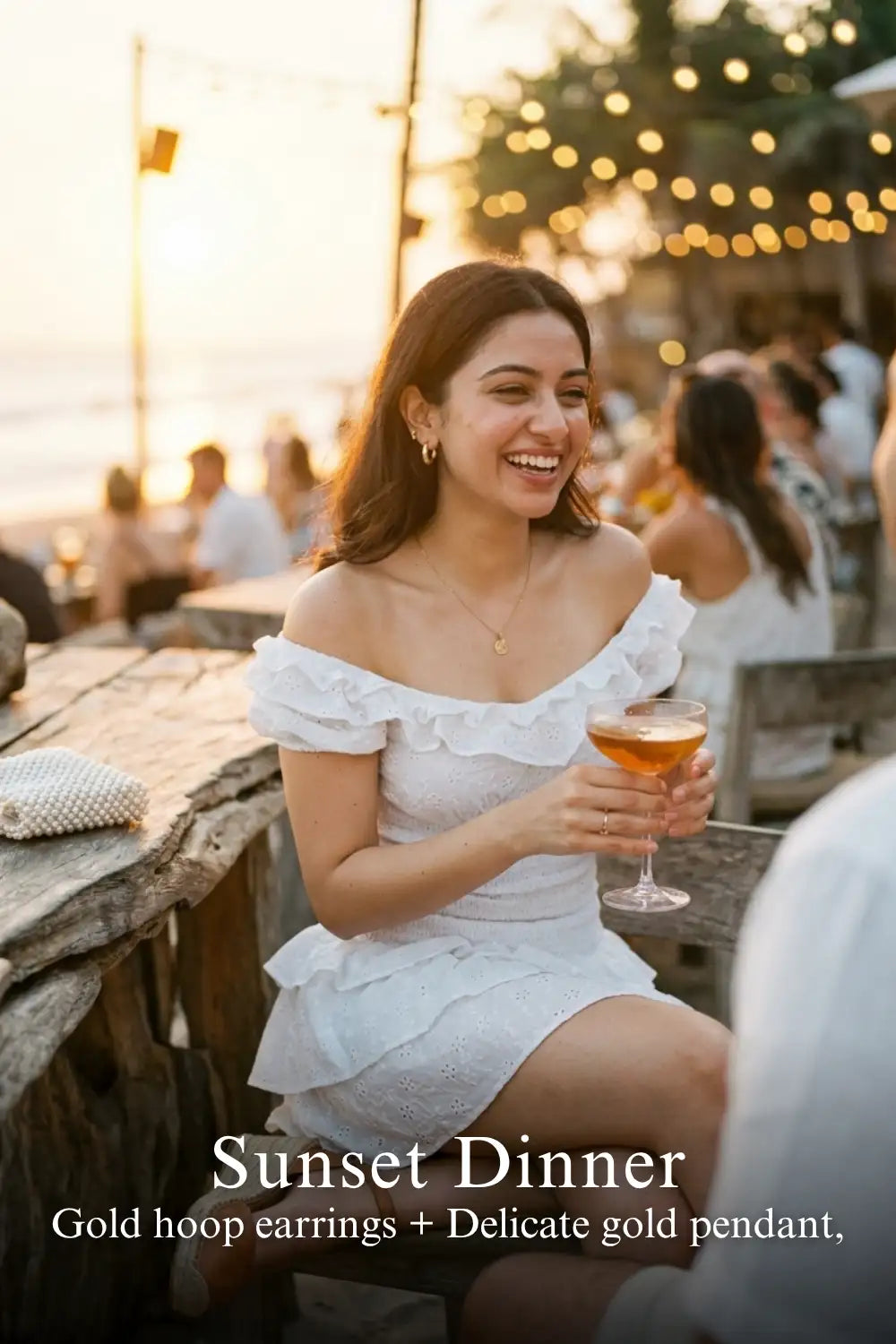 Woman in Pretty Pixie white eyelet ruffle mini dress styled for a sunset dinner