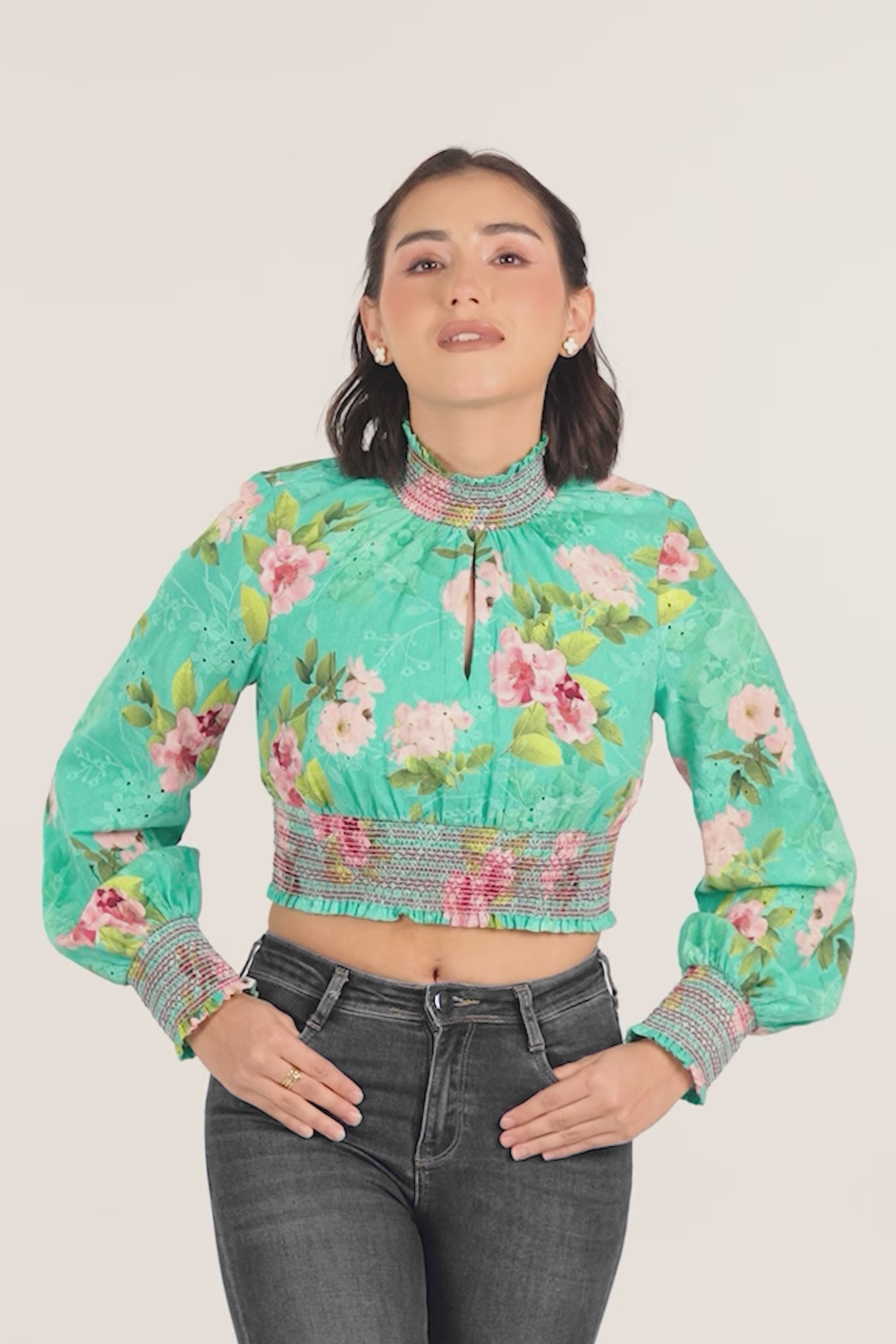 woman wearing green floral smocked crop top with full sleeves, stylish casual fashion