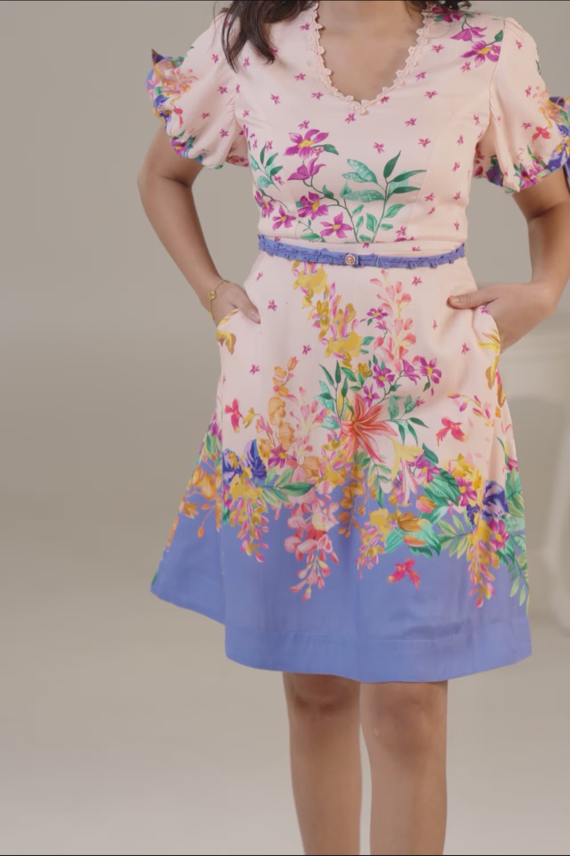 Pink and blue floral short dress with puff sleeves.