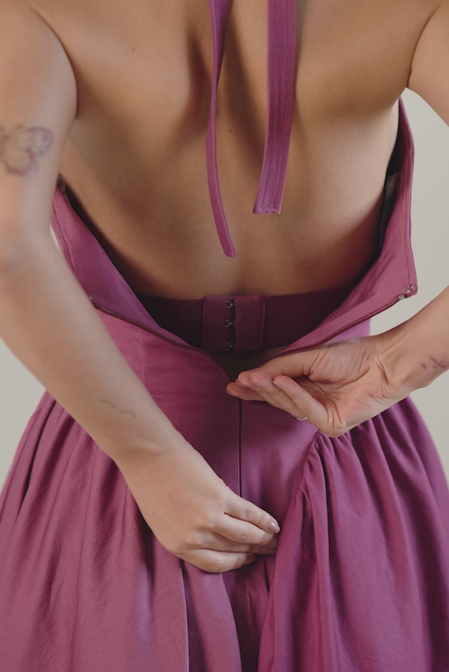 Plum halter neck midi dress front view, sleeveless fit and flare design.